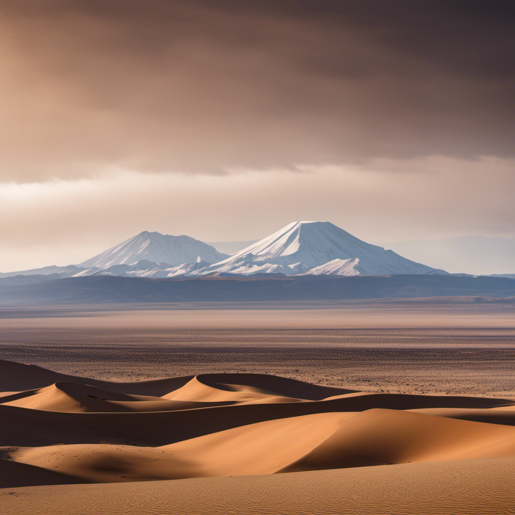 An image showcasing the vast expanse of the Atacama Desert, enveloped by towering sand dunes that stretch endlessly towards the horizon, while the majestic Andes mountain range looms in the background